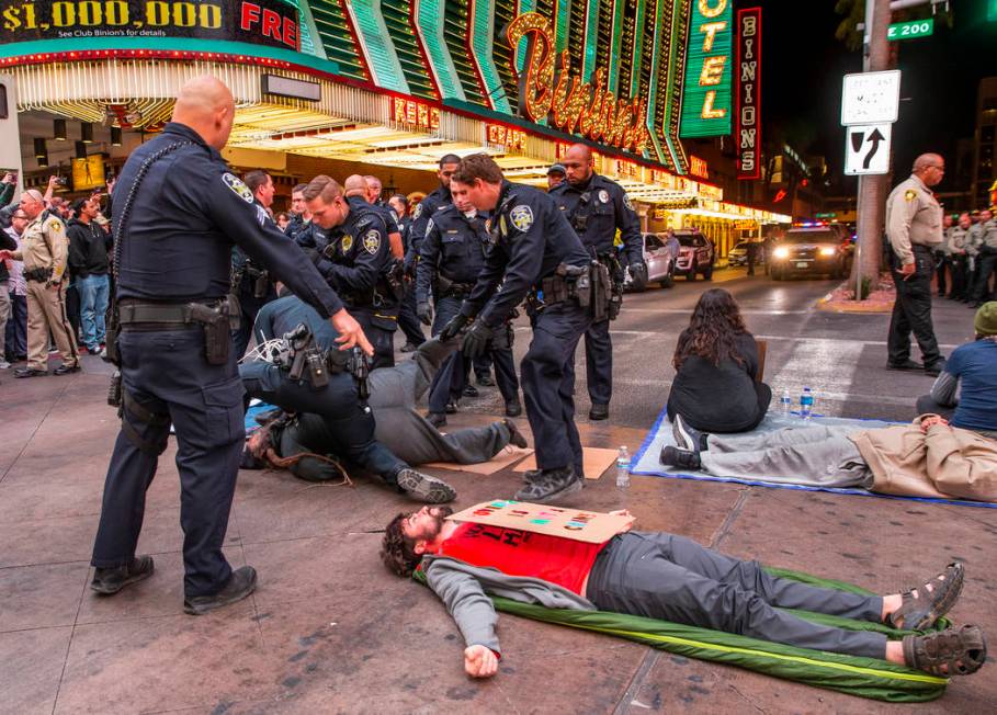 Las Vegas Metropolitan Police officers arrest local activists blocking Casino Center Blvd. thro ...