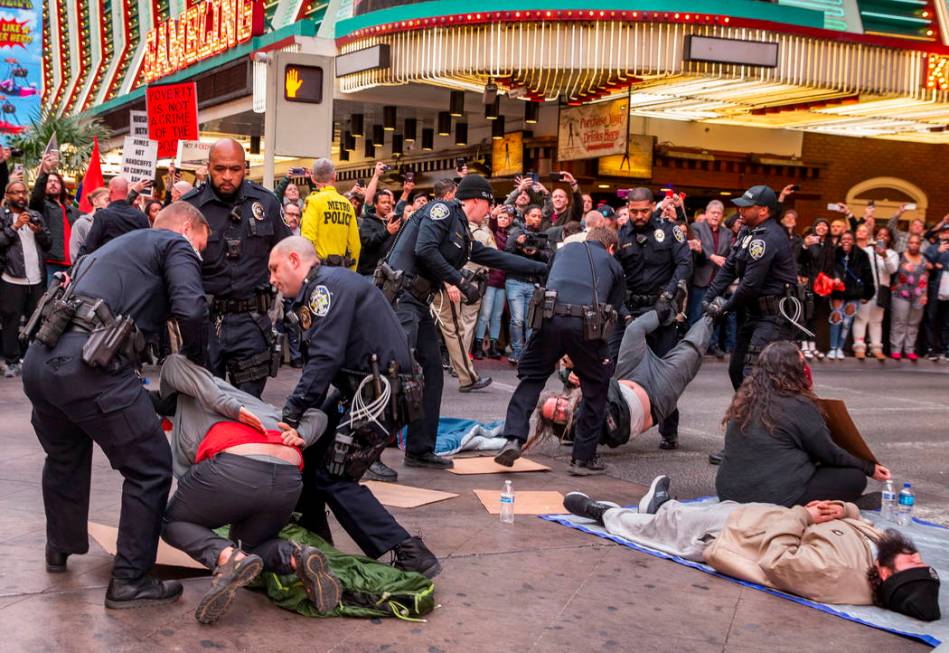 Las Vegas Metropolitan Police officers arrest local activists blocking Casino Center Blvd. thro ...