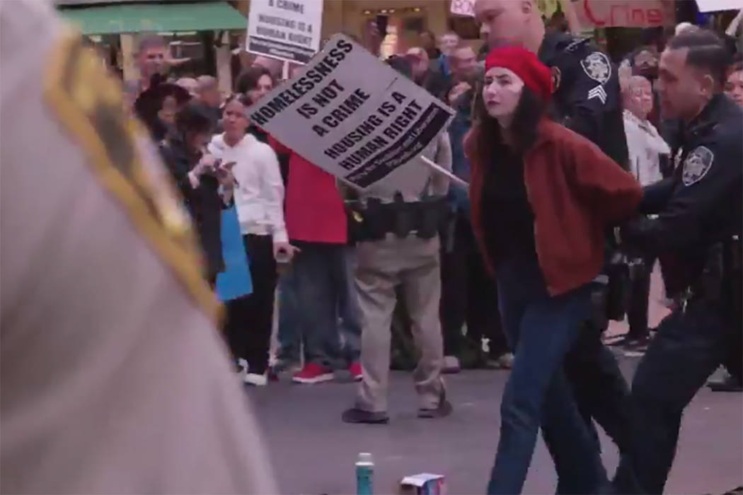 A woman is led away during the protests Monday, Jan. 20, 2020, in downtown Las Vegas. Activists ...