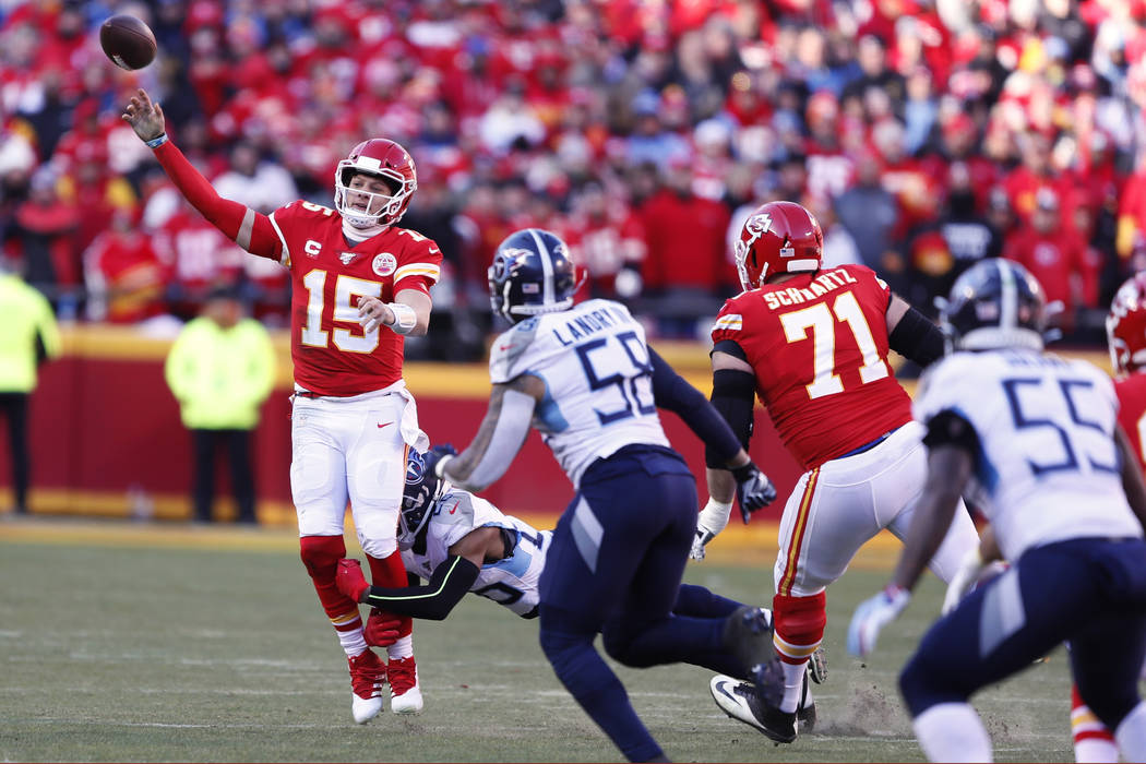 Kansas City Chiefs' Patrick Mahomes throws under pressure during the first half of the NFL AFC ...