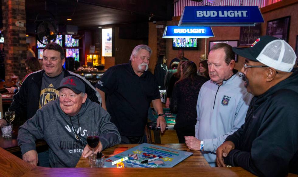 John Huntington, front left, is joined by other former teammates during the Las Vegas Aces slow ...