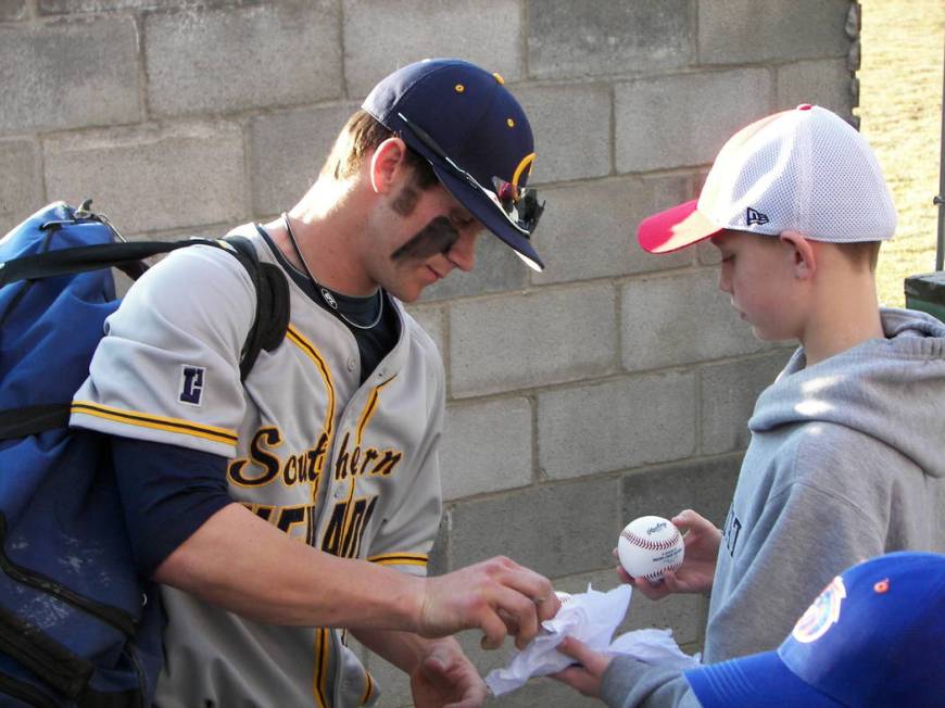 Bryce Harper is shown signing an autograph during his brief college baseball career at the Coll ...