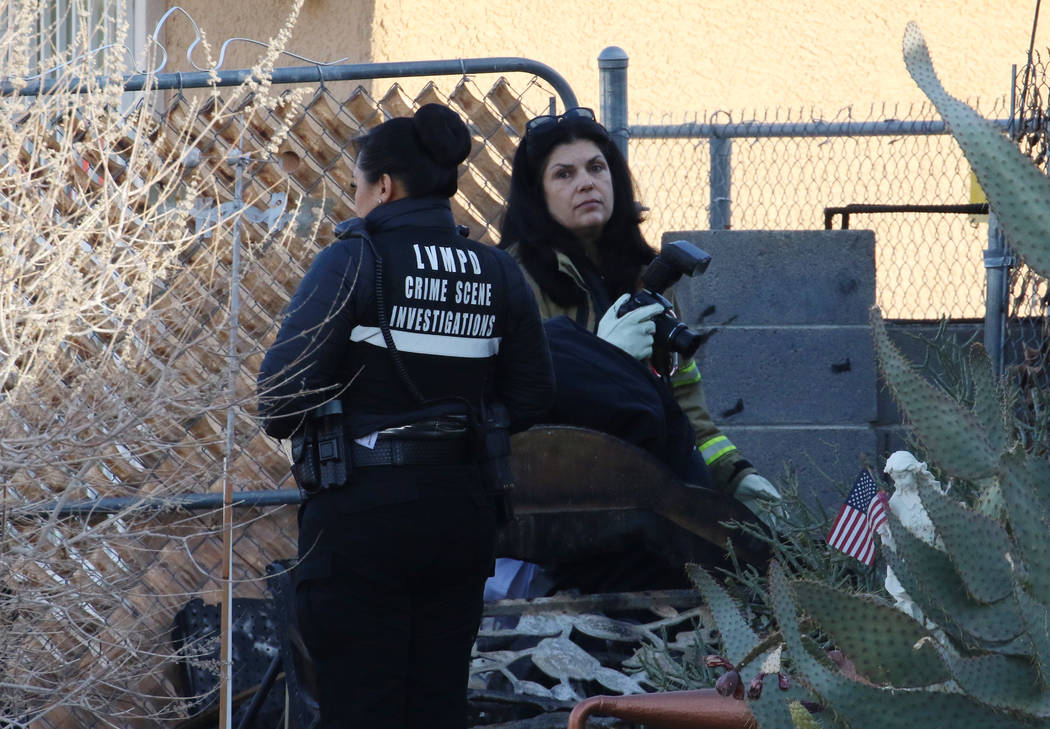 Las Vegas Metropolitan Police Department crime scene investigators work after a person died in ...