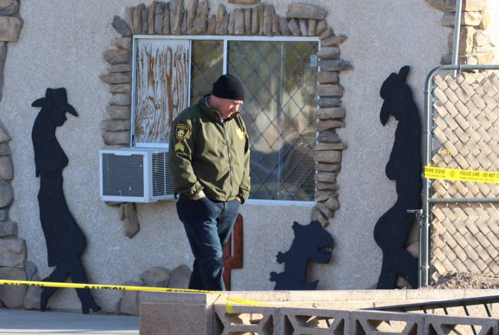 A Las Vegas police officer investigates after a person died in a shed fire at 2350 Lincoln Road ...