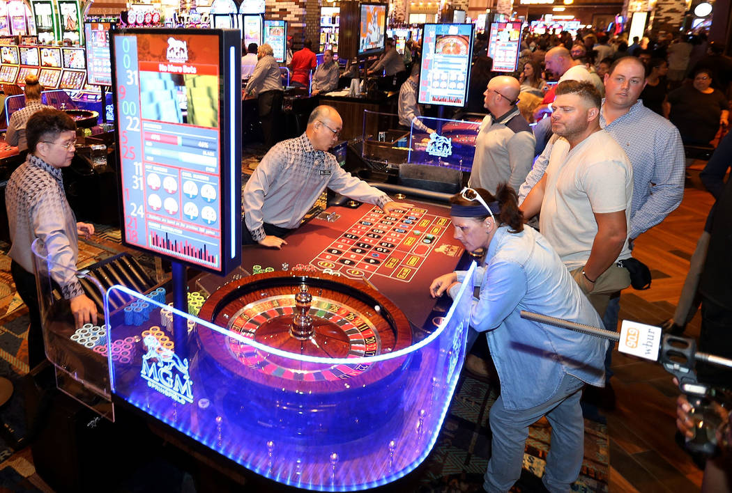 Guests play table games and machines during the opening of the MGM Springfield $960 million pro ...