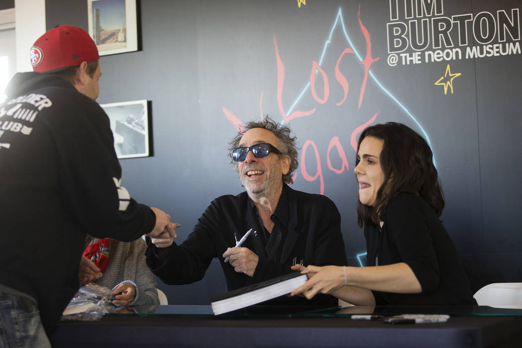 Director and artist Tim Burton, middle, greets fans during a book signing promoting his exhibit ...