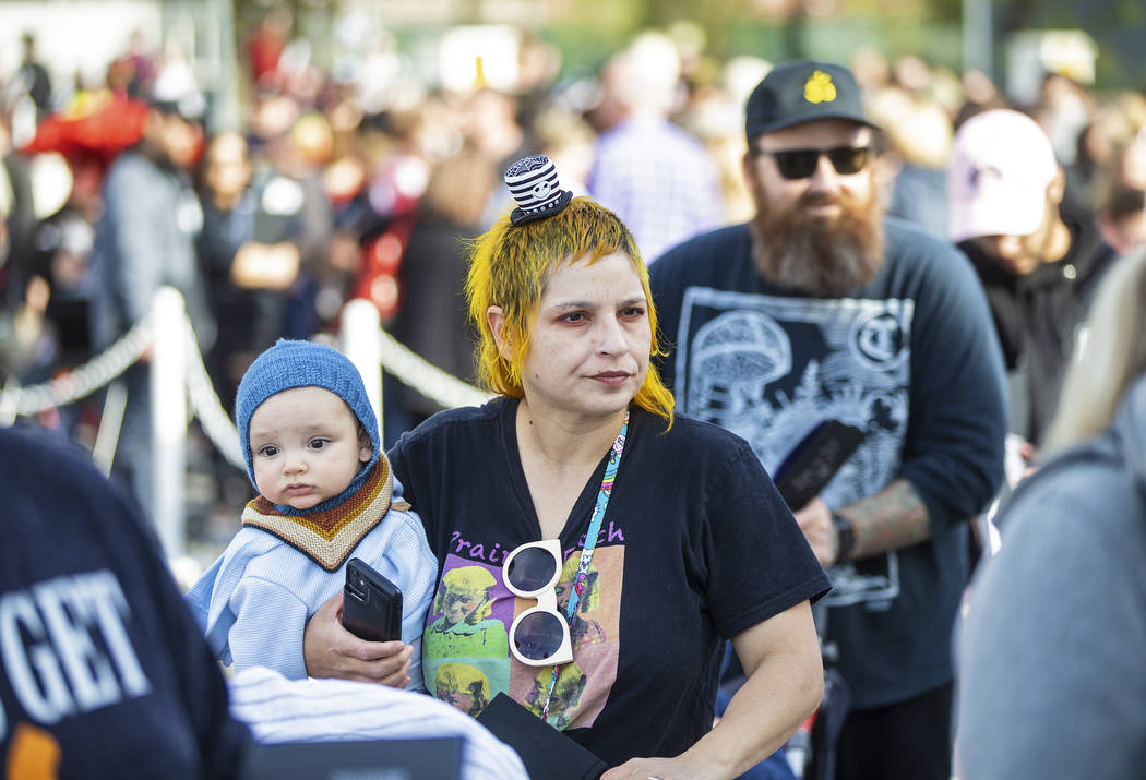 Julie Crowell, from Orange County, Calif., holds her son Jules, 8 months, as they wait in line ...