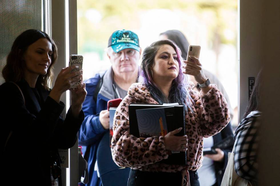 Mayra Nicola, middle, from Los Angeles, Calif., waits in line to meet director and artist Tim B ...