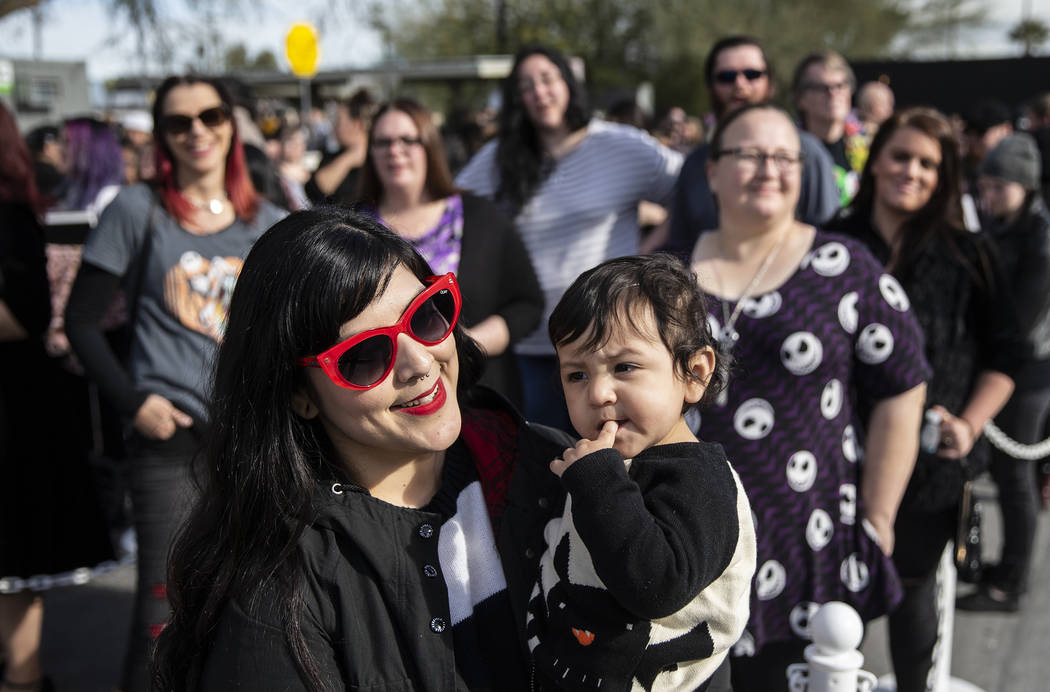 Andrea Arevalo, left, from Torrance, Calif., holds her son Max, 1, as they wait in line to meet ...