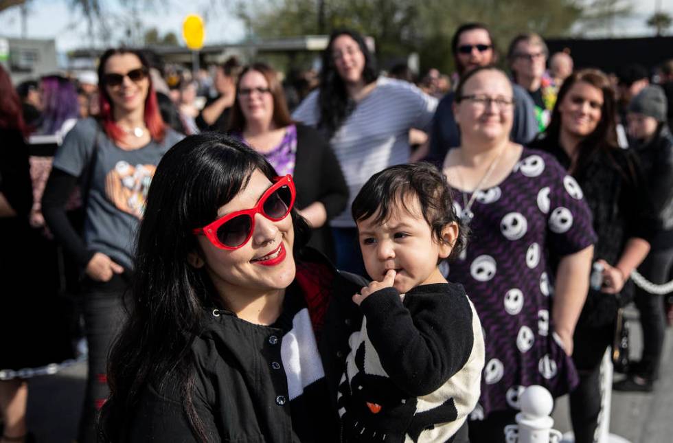 Andrea Arevalo, left, from Torrance, Calif., holds her son Max, 1, as they wait in line to meet ...