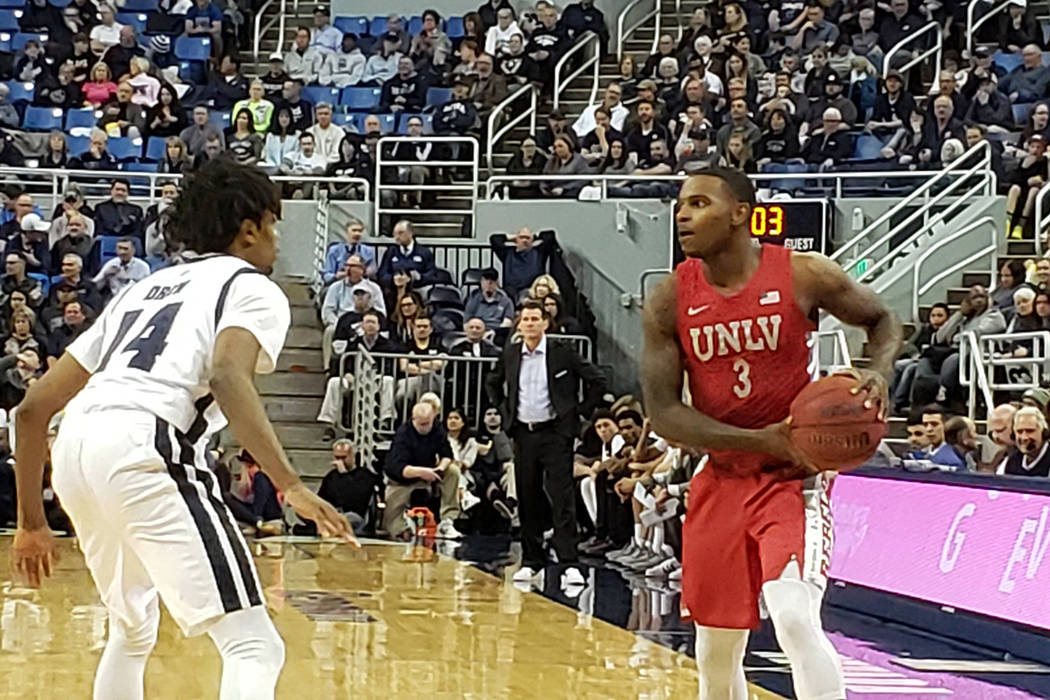 UNR's Lindsey Drew holds his ground against UNLV guard Amauri Hardy on Wednesday, Jan. 22, 2020 ...