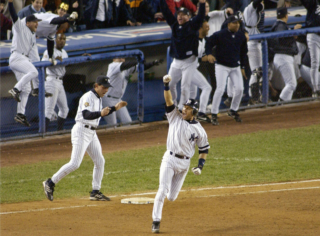 FIEE - In this Oct. 31, 2001, file photo, New York Yankees' Derek Jeter celebrates his game-win ...