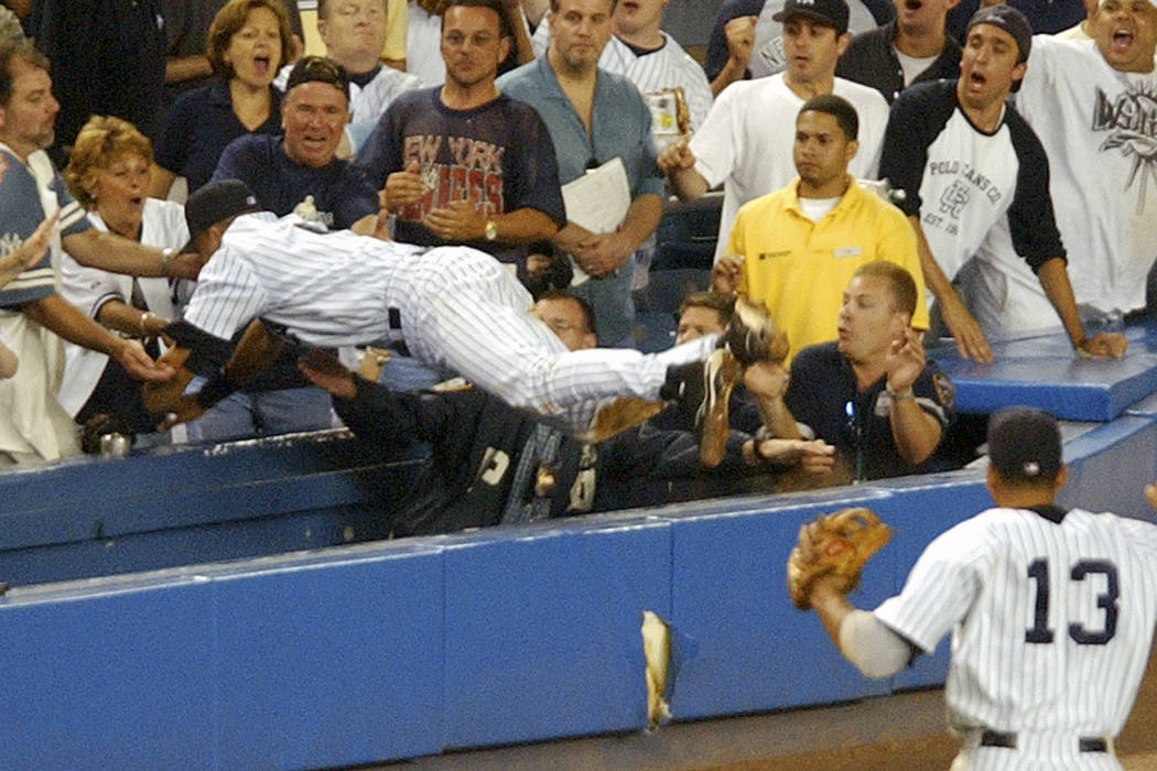 FILE - In this July 1, 2004, file photo, New York Yankees Derek Jeter dives to catch a fly foul ...