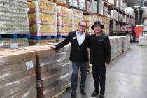 Three Square President and CEO Brian Burton and guitar legend Carlos Santana at Three Square fo ...