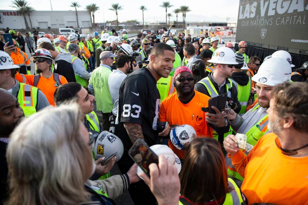 Raiders tight end Darren Waller takes photos with fans during a special announcement at the All ...