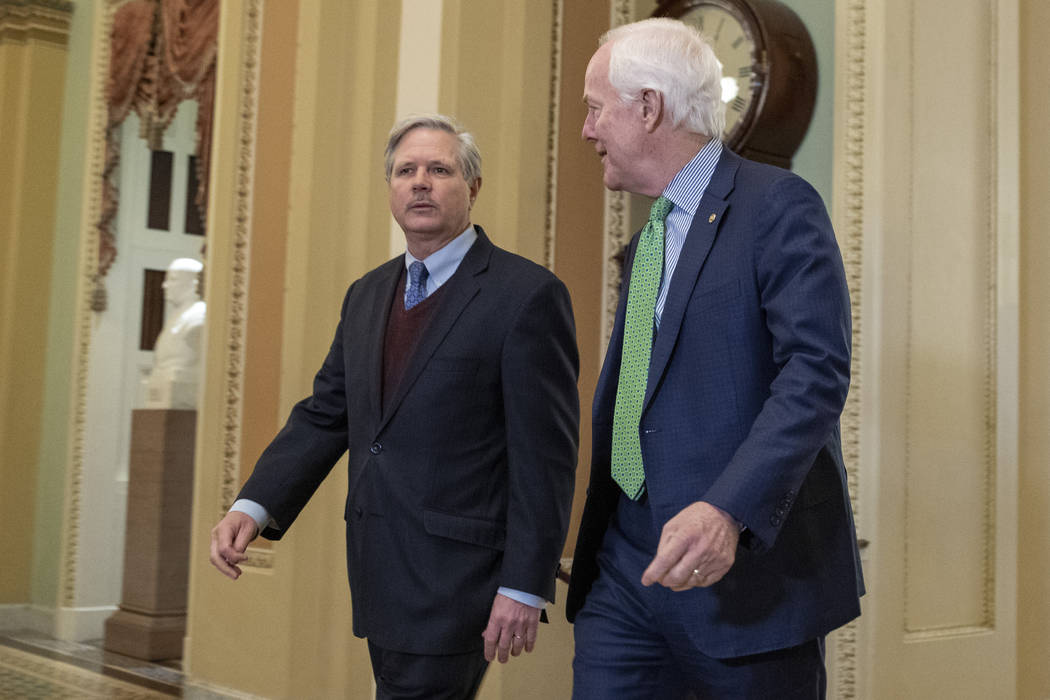 Sen. John Hoeven, R-N.D., left, talks with Sen. John Cornyn, R-Texas, as they walk to the Senat ...