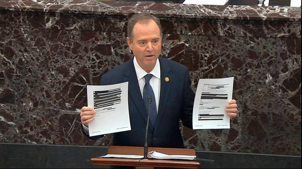 In this image from video, House impeachment manager Rep. Adam Schiff, D-Calif., holds redacted ...