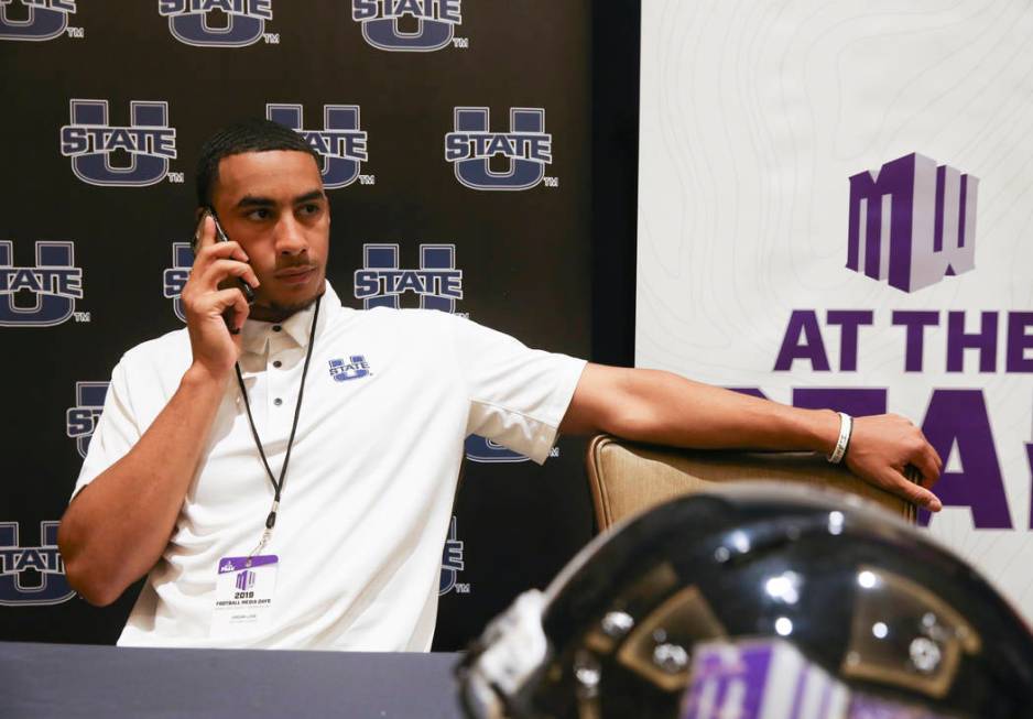 Utah State quarterback Jordan Love does a phone interview during Mountain West football media d ...
