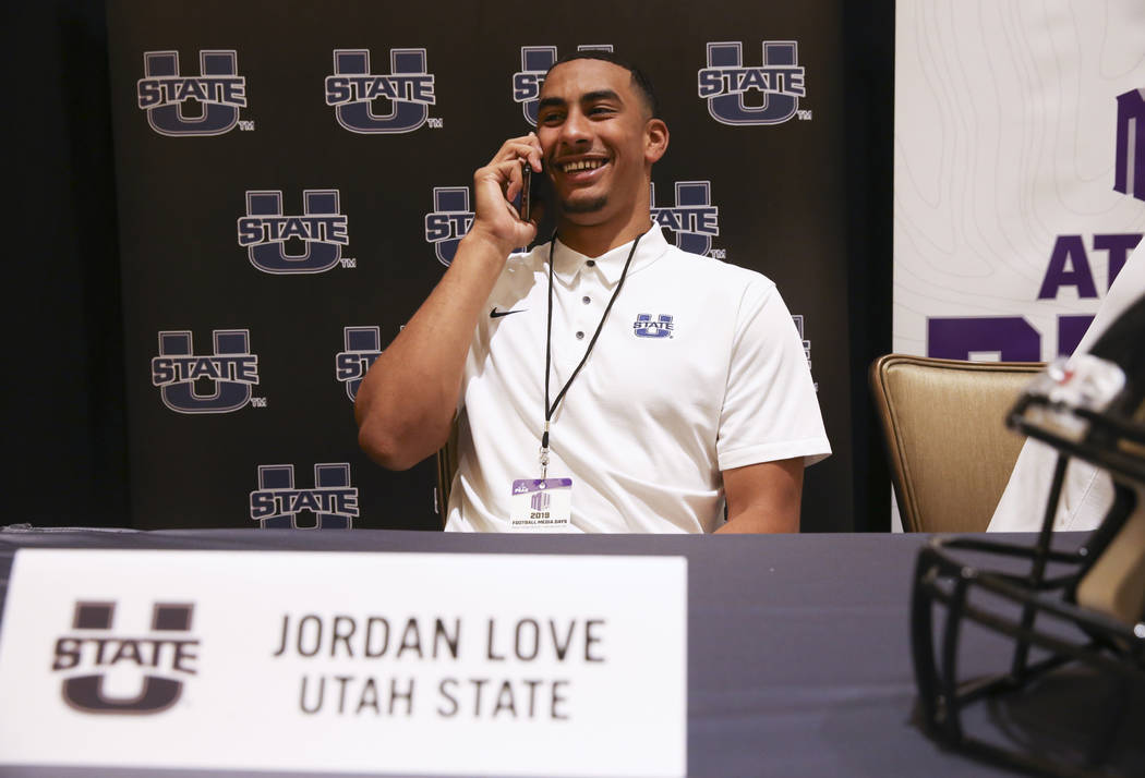 Utah State quarterback Jordan Love does a phone interview during Mountain West football media d ...