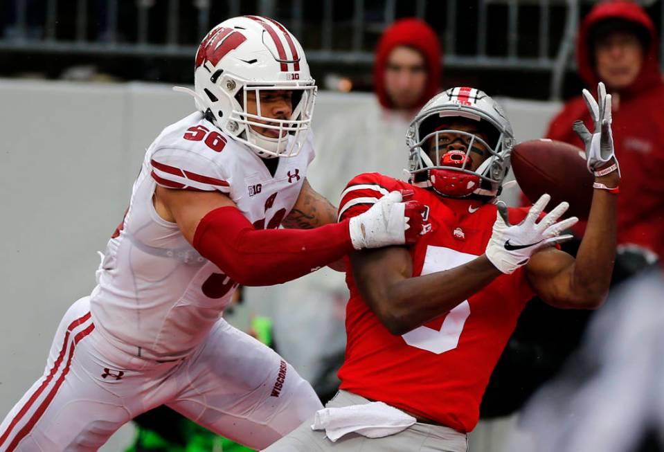 Wisconsin linebacker Zack Baun, left, interferes with Ohio State receiver Garrett Wilson during ...