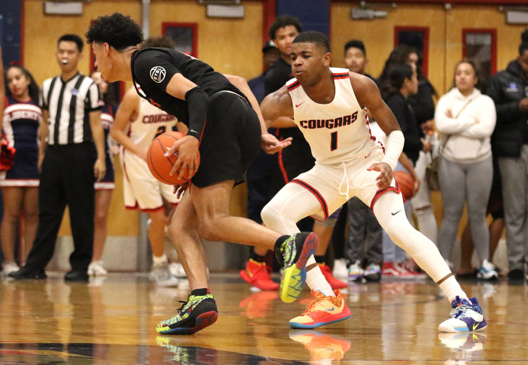 Coronado High's Jaden Hardy (1) defends Liberty High's guard Julian Strawther (0) during the th ...