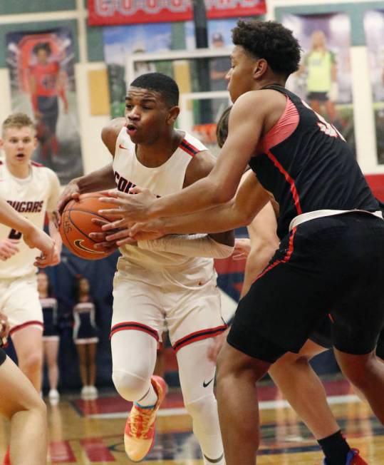 Coronado High's Jaden Hardy (1) tries to drive past Liberty High's forward Joshua Jefferson, ri ...