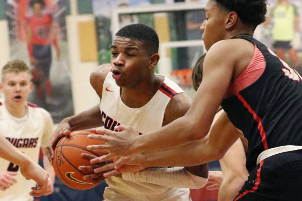 Coronado High's Jaden Hardy (1) tries to drive past Liberty High's forward Joshua Jefferson, ri ...