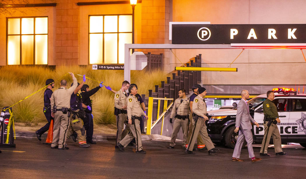 Metropolitan Police Department officers move to a Fashion Show Mall entrance near Macy's for a ...