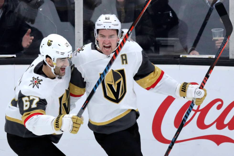 Vegas Golden Knights right wing Mark Stone, right, celebrates his goal against Boston Bruins go ...