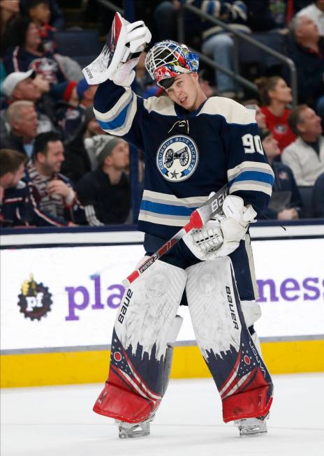 Columbus Blue Jackets' Elvis Merzlikins, of Latvia, skates back on to the ice after a time put ...