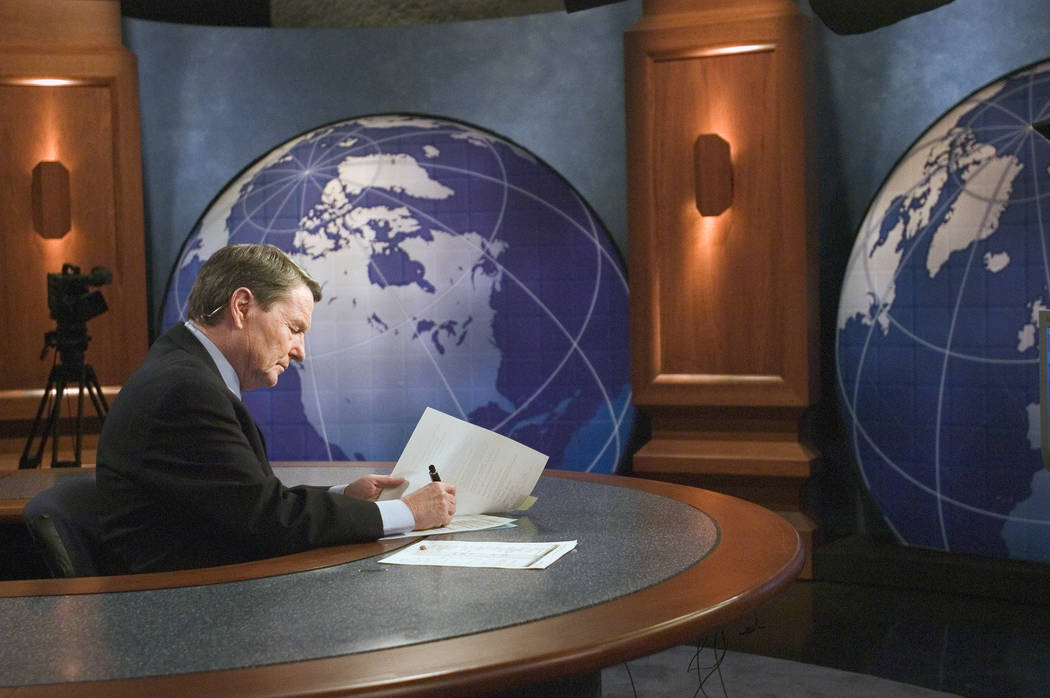 This 2004 image released by PBS shows journalist Jim Lehrer on the set of "PBS NewsHour wi ...