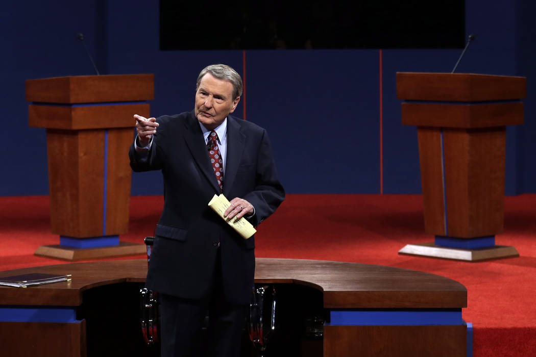 FILE - This Oct. 3, 2012 file photo shows moderator Jim Lehrer addressing the audience before t ...