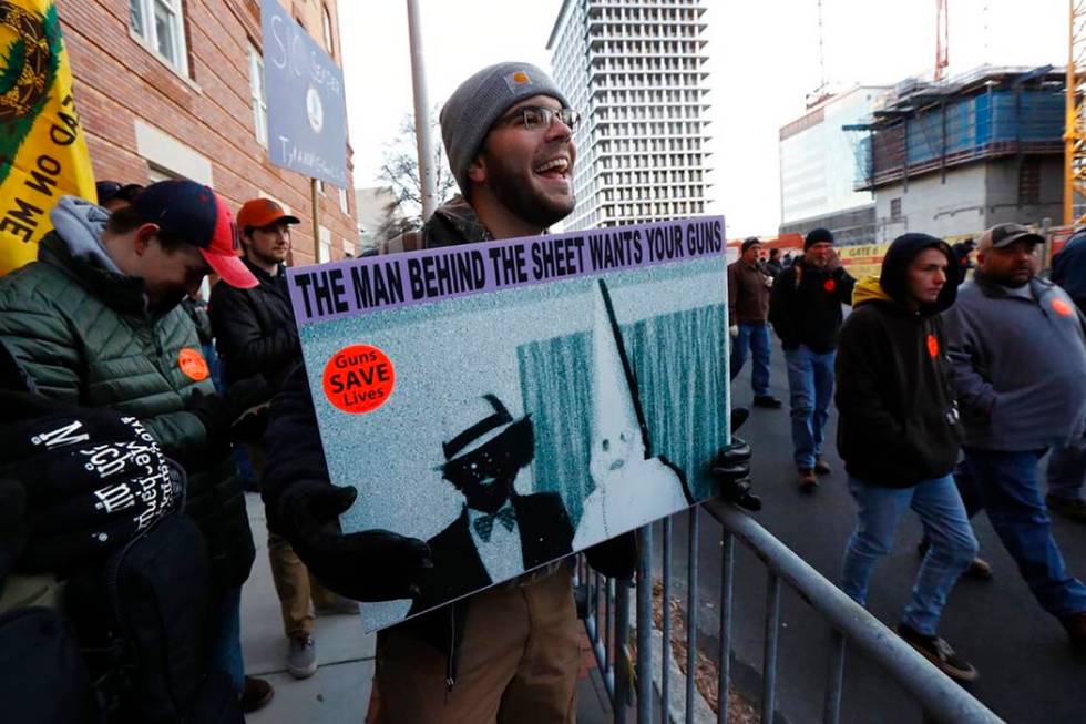 Demonstrators stand outside a security zone before a pro gun rally, Monday, Jan. 20, 2020, in R ...