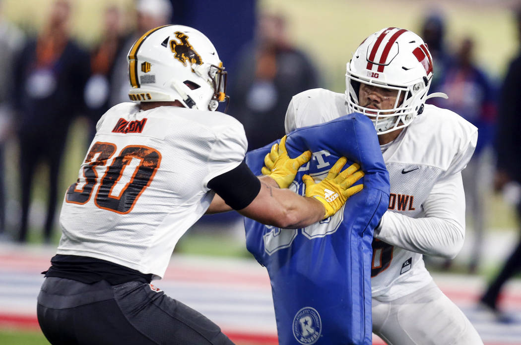 Wisconsin's Zack Barn (56) blocks Wyoming's Logan Wilson (30) as the North squad practices for ...