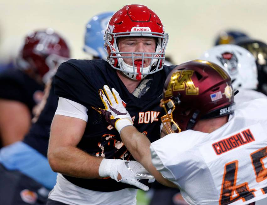 Dayton's Adam Troutman (84) blocks out Minnesota's Carter Coughlin as the North squad practices ...