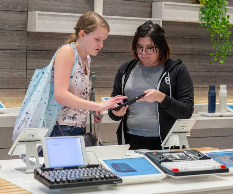 b8ta tester Melissa Avalos, right, helps Jamie Halverson of Iowa City, Iowa, sign up for the ne ...