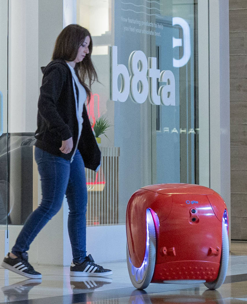 The gita robot follows b8ta store manager Laynie Shrago as she walks backward into the recently ...