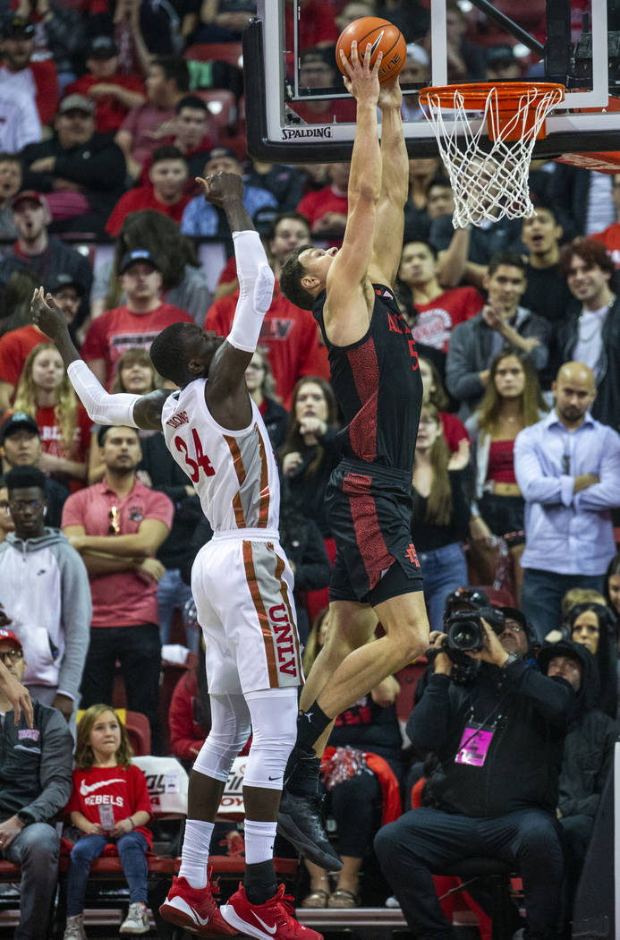 San Diego State Aztecs forward Yanni Wetzell (5, right) dunks the ball over UNLV Rebels forwar ...