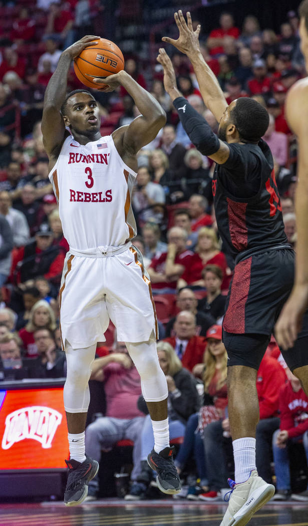 UNLV Rebels guard Amauri Hardy (3, left) elevates for a 3-point shot attempt over San Diego Sta ...