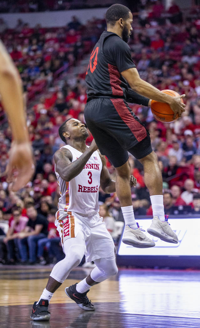 UNLV Rebels guard Amauri Hardy (3, left) loses a rebound to San Diego State Aztecs guard Jordan ...