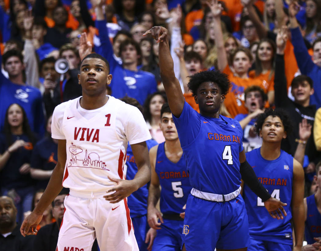 Bishop Gorman's Jonathan Braggs (4) watches his shot go in alongside Coronado's Jaden Hardy (1) ...