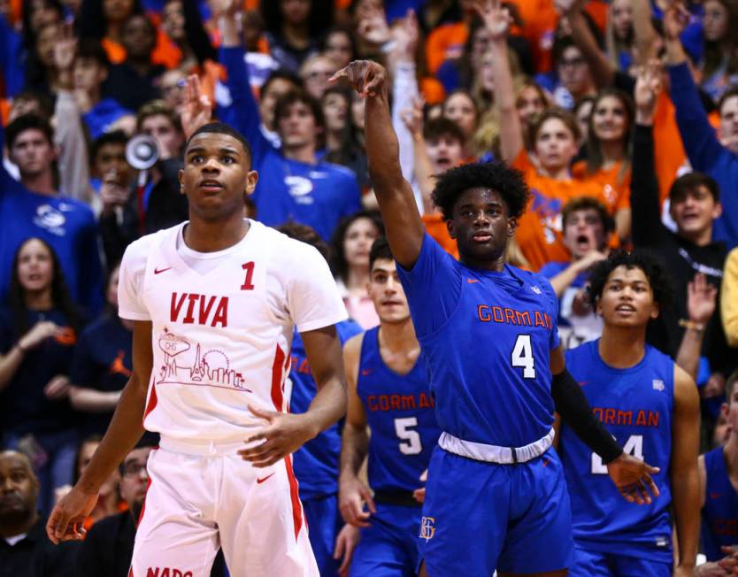 Bishop Gorman's Jonathan Braggs (4) watches his shot go in alongside Coronado's Jaden Hardy (1) ...