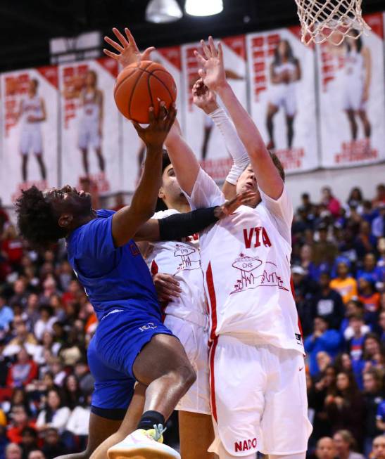 Bishop Gorman's Jonathan Braggs (4) shoots against Coronado's Jaxon Kohler (0) during the secon ...