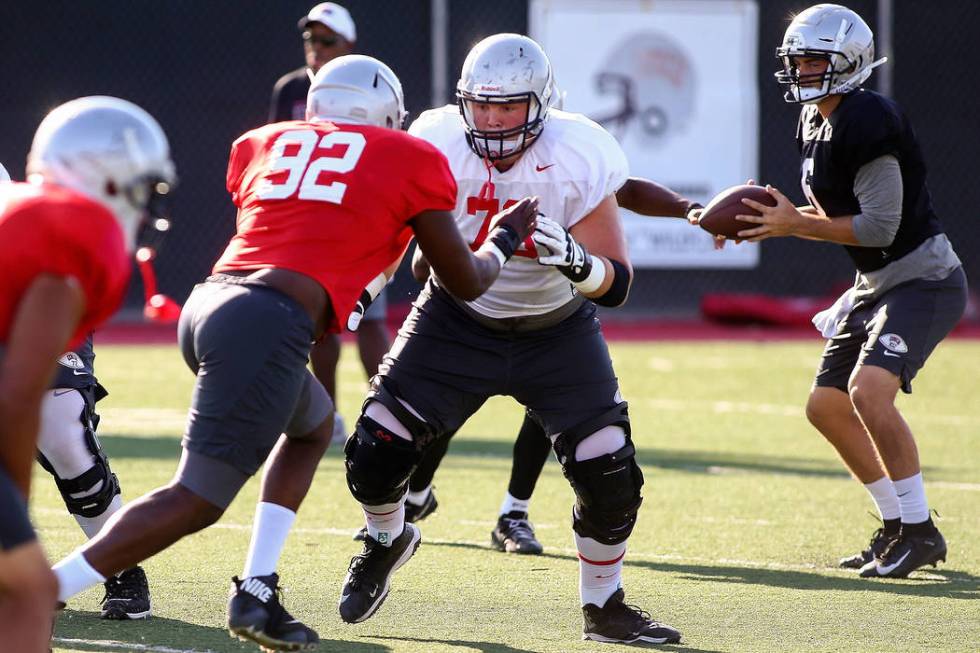 UNLV Rebels offensive lineman Ashton Morgan (73) defends against UNLV Rebels defensive lineman ...