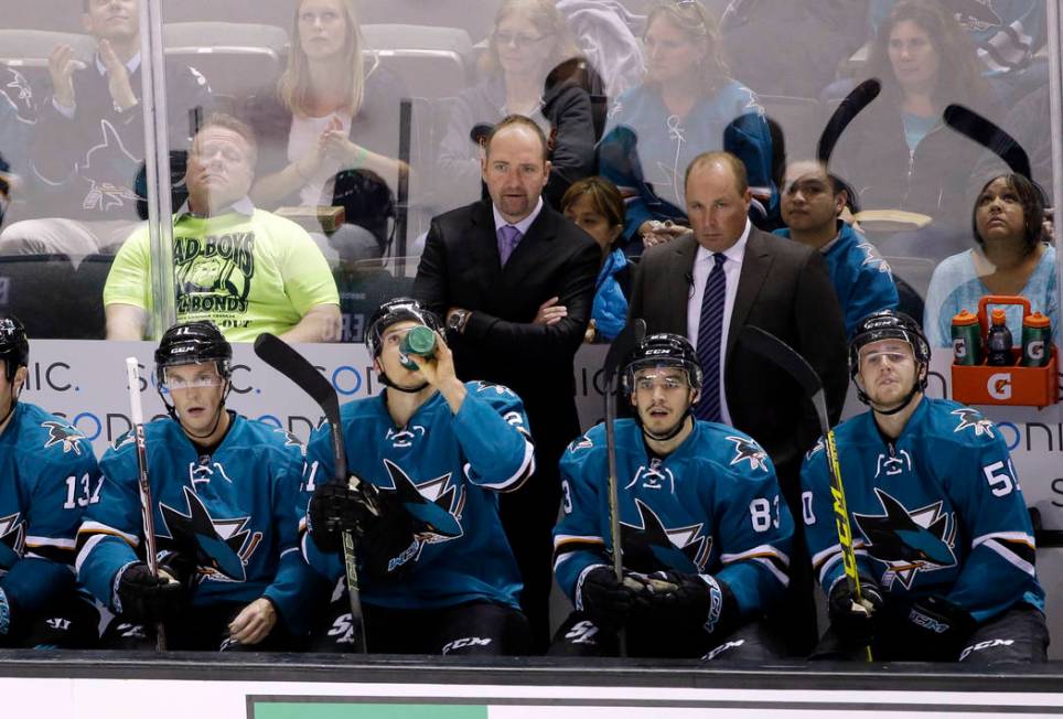 San Jose Sharks head coach Peter DeBoer watches game action alongside assistant coach Steve Spo ...