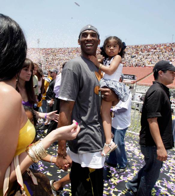 In this June 17, 2009 file photo Los Angeles Lakers' Kobe Bryant smiles as he and his daughter ...
