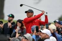 Tiger Woods watches his tee shot on the second hole of the South Course at Torrey Pines Golf Co ...