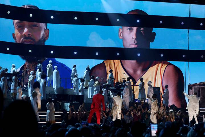 YG, from left, John Legend, Kirk Franklin, DJ Khaled and Meek Mill point to a screen showing Ni ...