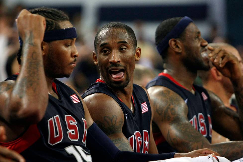 Kobe Bryant, center, and Carmelo Anthony, left, of the USA men's basketball team chat during a ...