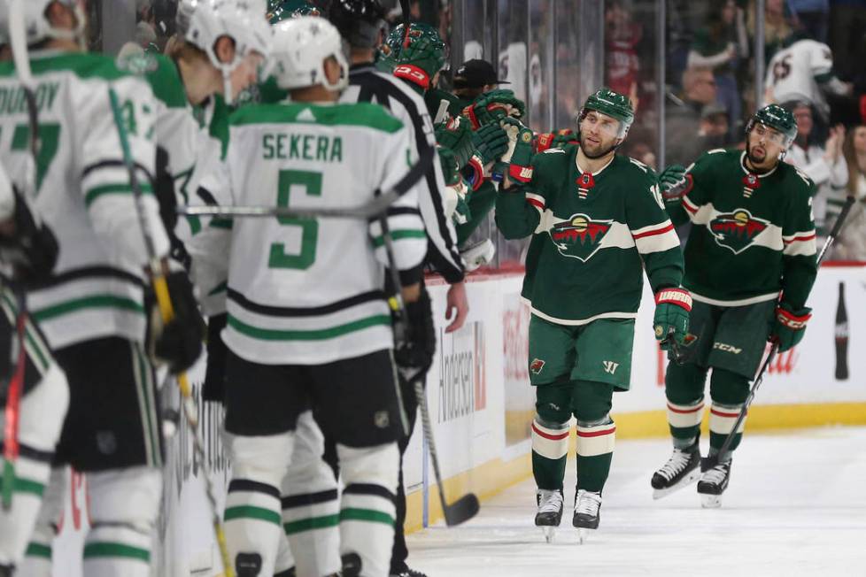 Minnesota Wild's Jason Zucker high fives his teammates after scoring a goal against the Dallas ...